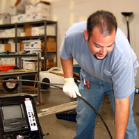 Plumber demonstrates the usage of a drain inspection camera